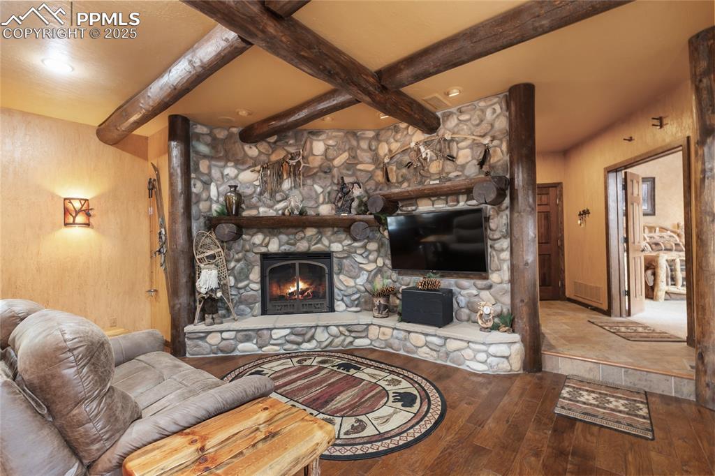 Image 24 of 46: Primary wing family room with floor to ceiling stone fireplace