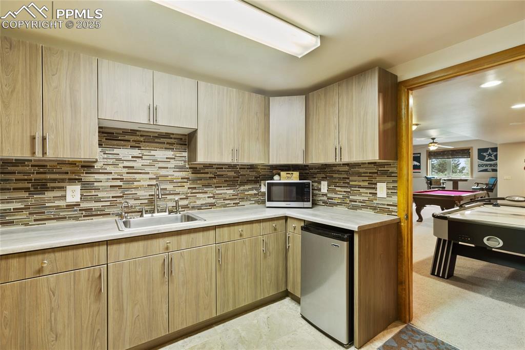 Image 40 of 46: Lower level kitchen for easy access, entertainment and multi-generational l