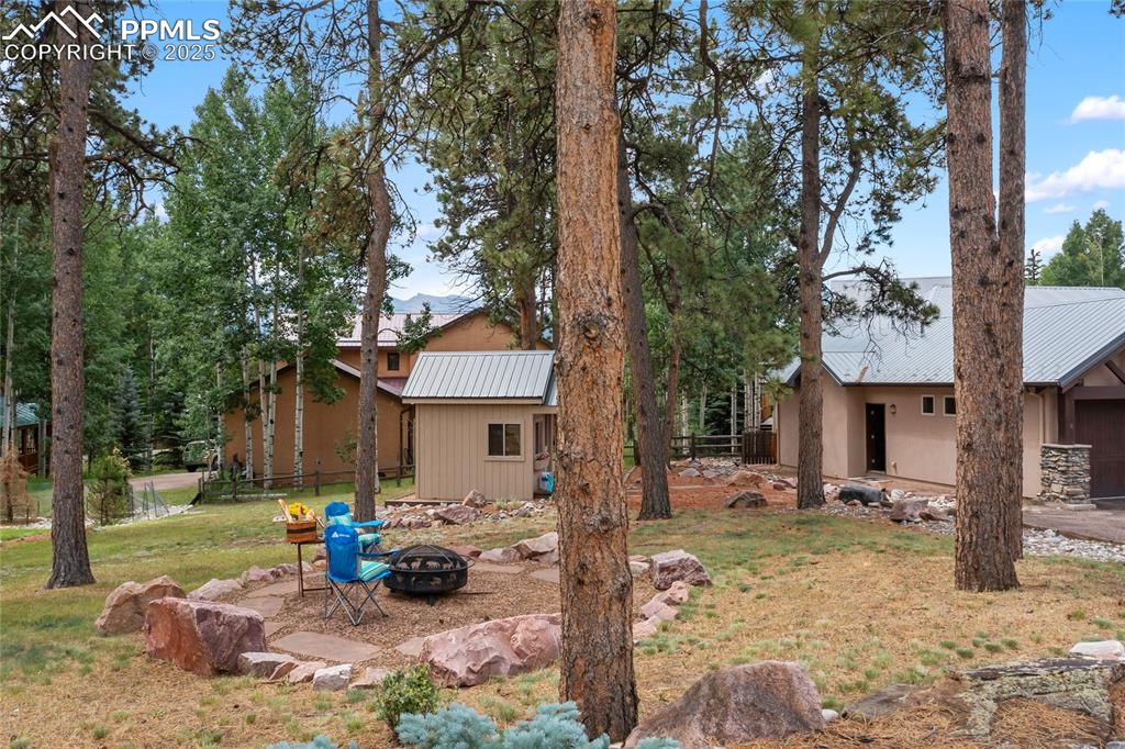 Image 43 of 46: Love this bonus side yard firepit area!