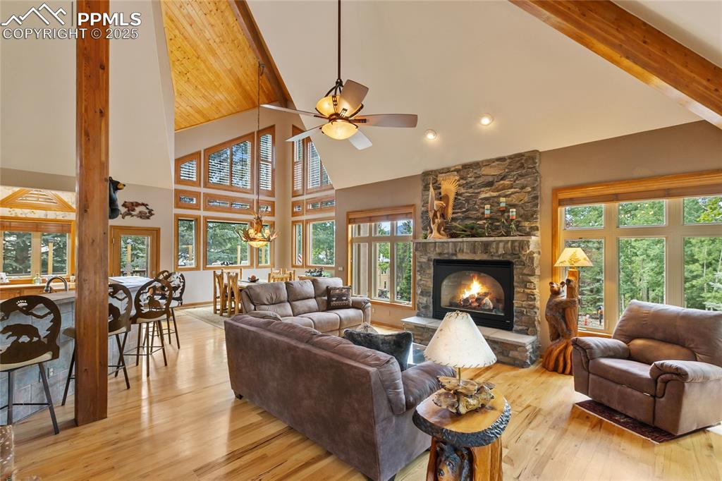 Image 9 of 46: Welcome home to soaring vaulted ceilings, floor to ceiling windows and a st