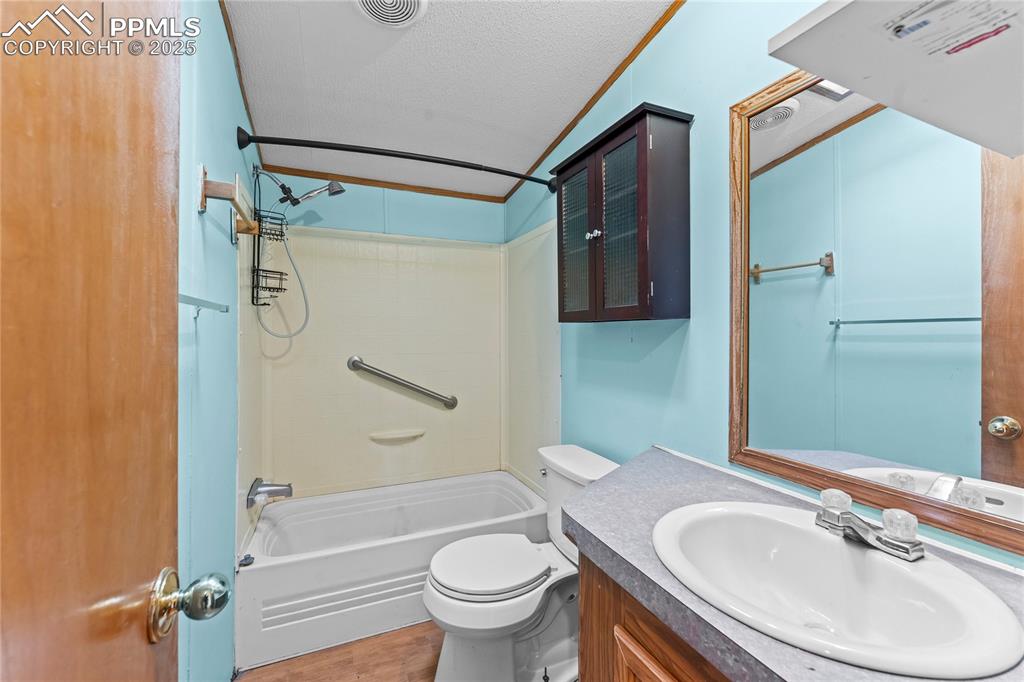 Image 12 of 32: Bathroom with shower / washtub combination, vanity, and a textured ceiling