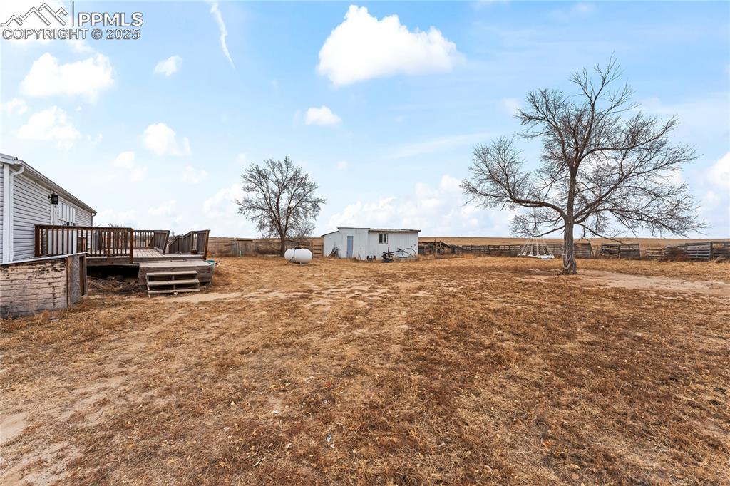 Image 23 of 32: View of yard featuring a deck and an outbuilding