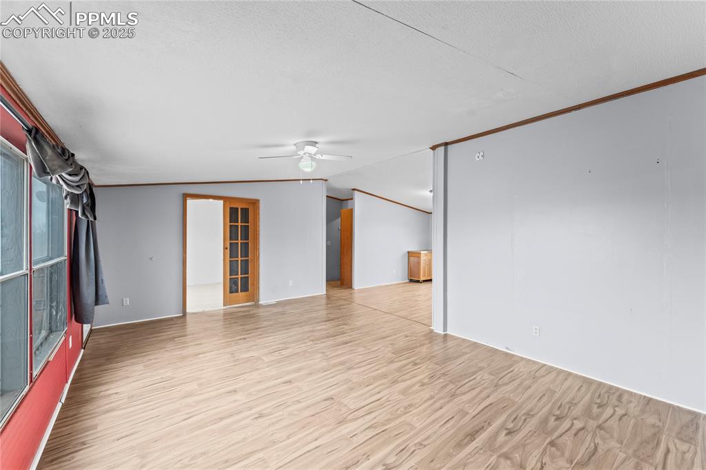 Image 5 of 32: Spare room featuring vaulted ceiling, light wood-style flooring, ceiling fa