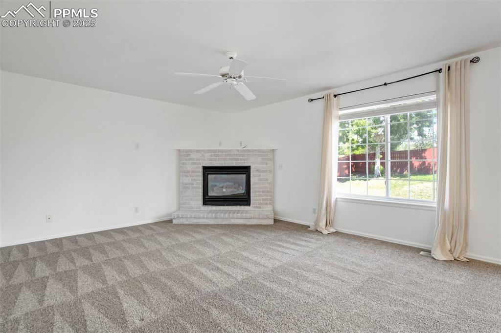Image 19 of 48: Cozy painted brick fireplace