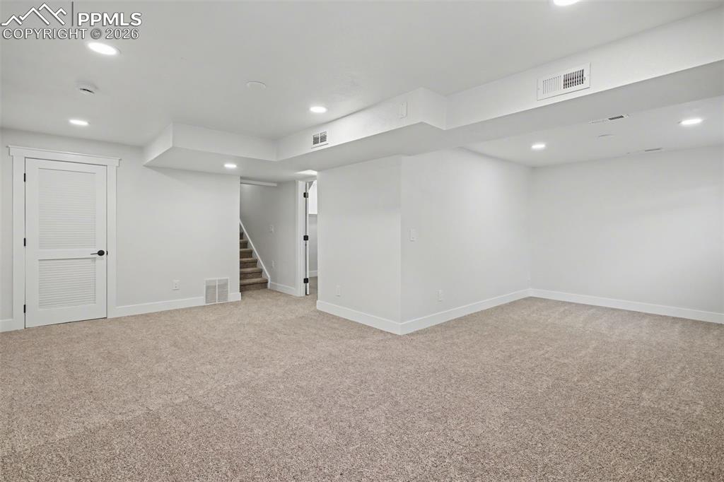 Image 34 of 47: Expansive Basement Living Area Ready for Movie Nights or Game Days