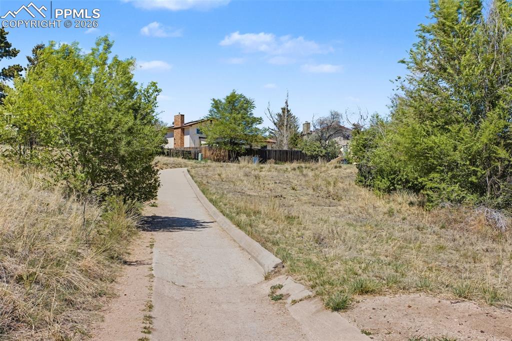Image 46 of 47: Peaceful Neighborhood Trail Surrounded by Nature