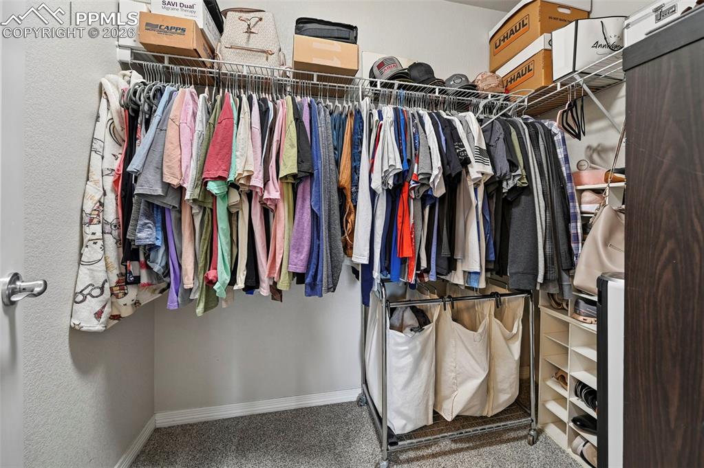 Image 28 of 49: Primary walk-in closet