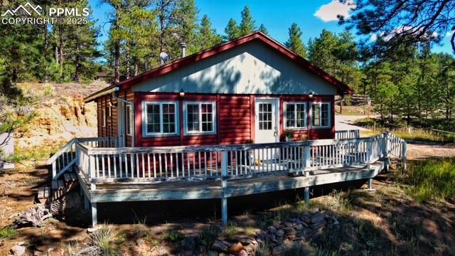 Image 2 of 15: Rear view of property featuring a deck