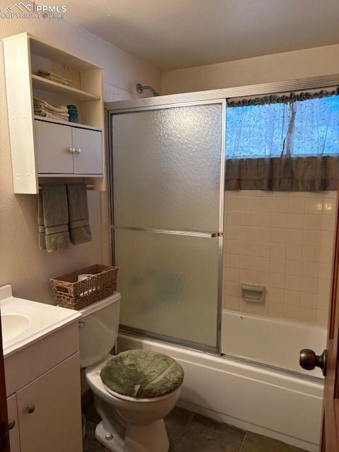 Image 7 of 15: Bathroom featuring vanity, combined bath / shower with glass door, a textur