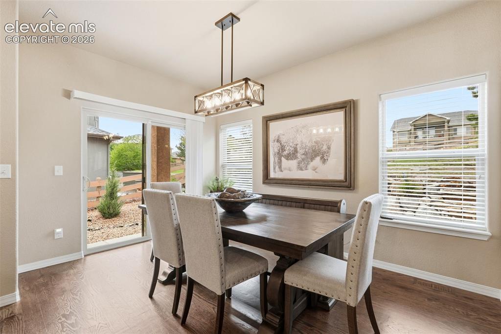 Image 12 of 47: Light and bright dining room with updated light fixture 