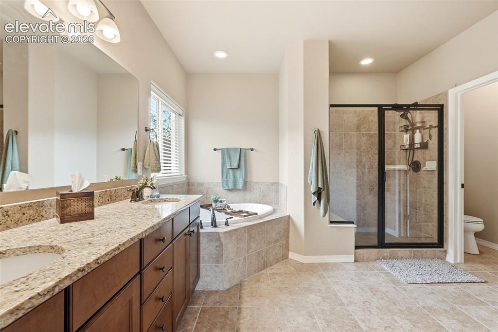 Image 23 of 47: Primary ensuite with 5-piece bath. Granite countertops in all bathrooms, la