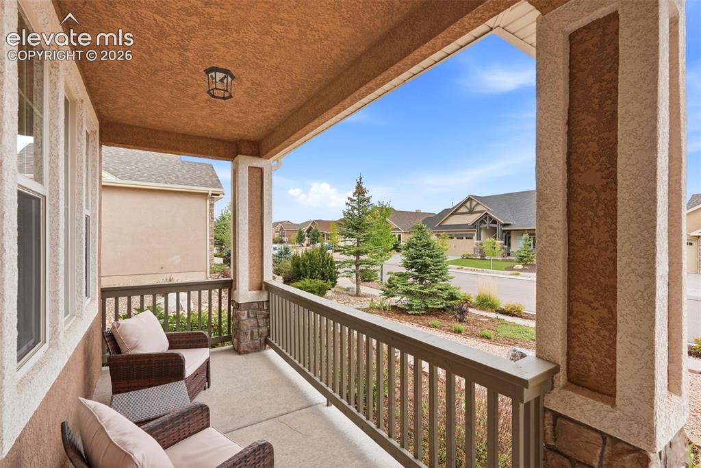 Image 5 of 47: Covered front porch. Perfect for taking in the mountain views and Air Force