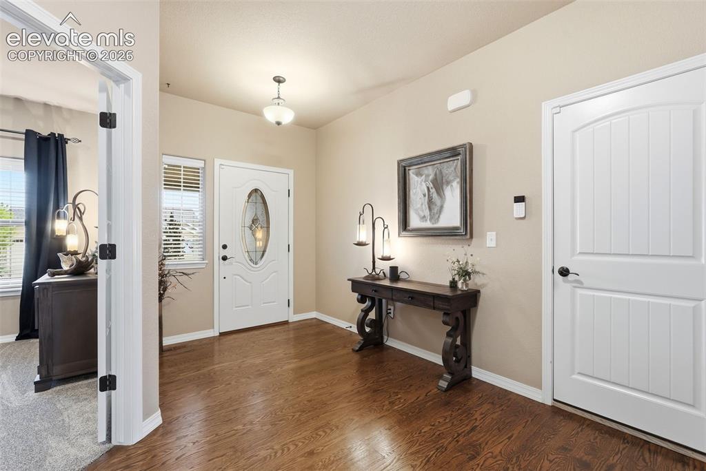 Image 6 of 47: Entry with hardwood floors 