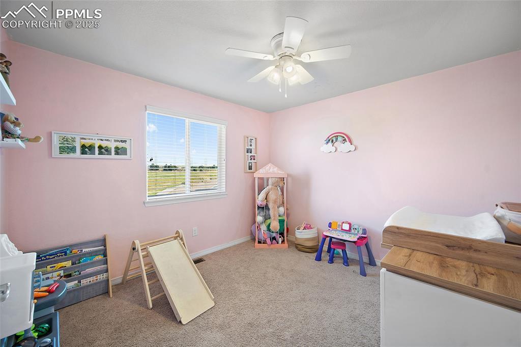 Image 27 of 38: Bedroom featuring light carpet and a ceiling fan