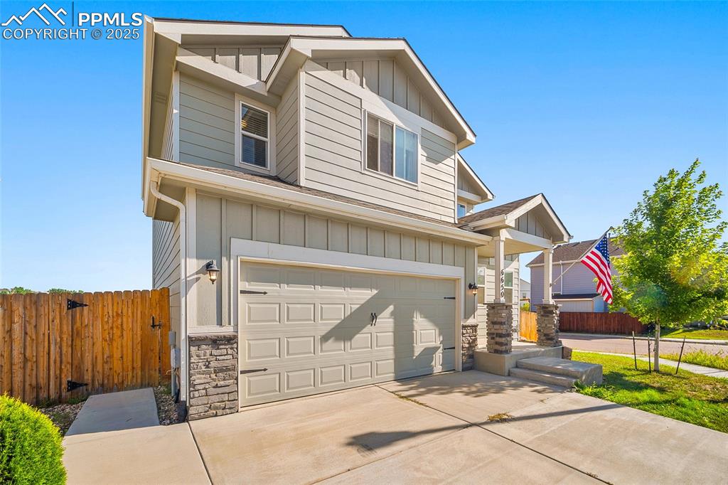 Image 3 of 38: View of front of house with an attached garage, board and batten siding, co
