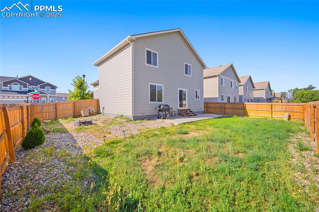 Image 31 of 38: Rear view of house with a patio area, a residential view, a fenced backyard