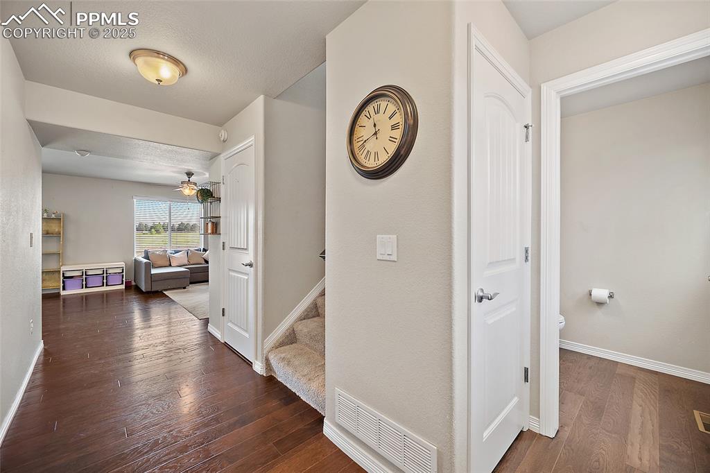 Image 4 of 38: Hallway featuring dark wood-style floors