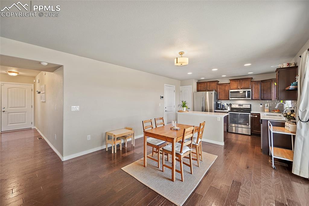 Image 6 of 38: Dining room featuring recessed lighting and dark wood finished floors