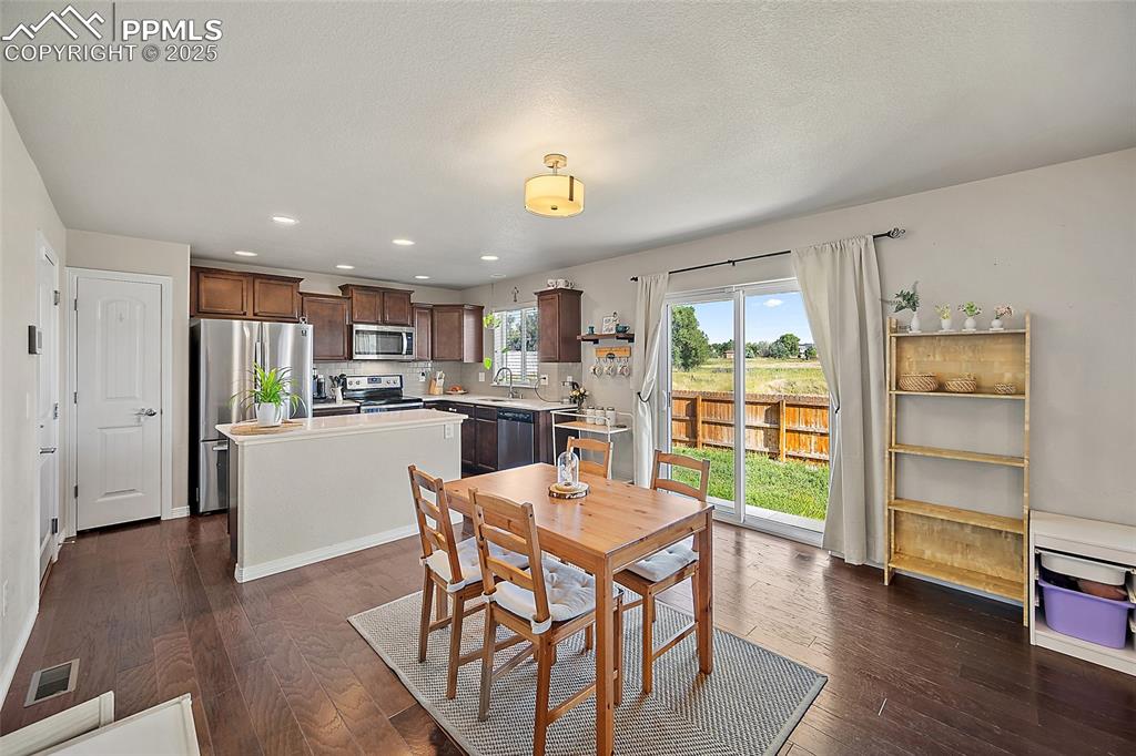 Image 7 of 38: Dining area featuring recessed lighting and dark wood-type flooring