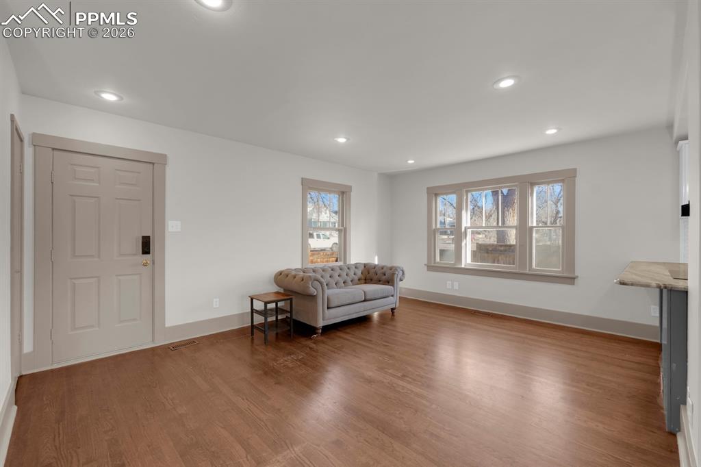 Image 14 of 39: Living area featuring light wood style floors and recessed lighting