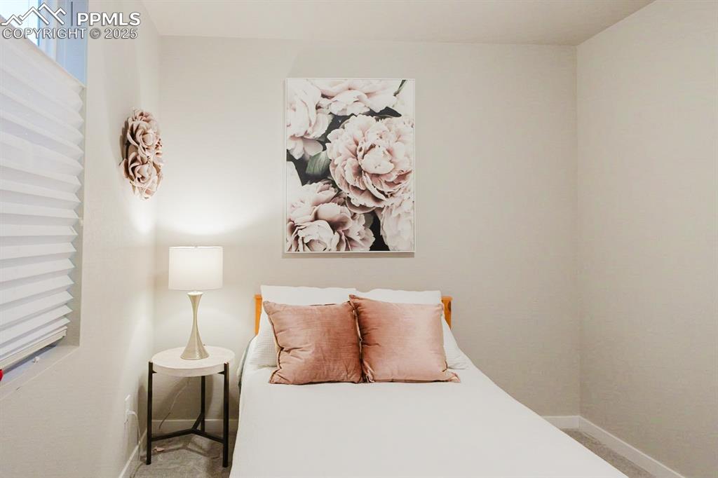 Image 14 of 37: This bedroom is tucked off the rear of the main floor for privacy and quiet