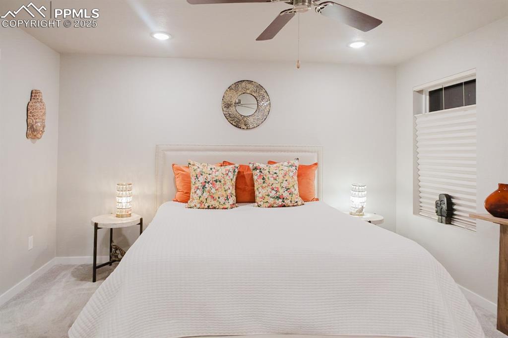 Image 19 of 37: The primary bedroom has big windows for lots of natural light.