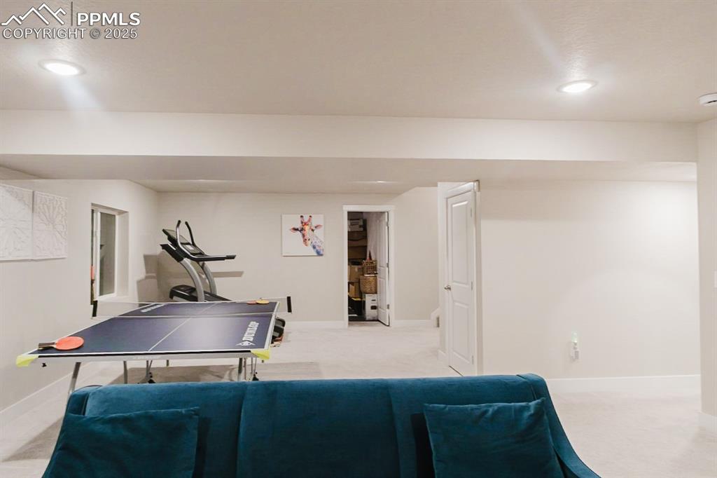 Image 31 of 37: This basement family room is the perfect space for a casual hang-out area.