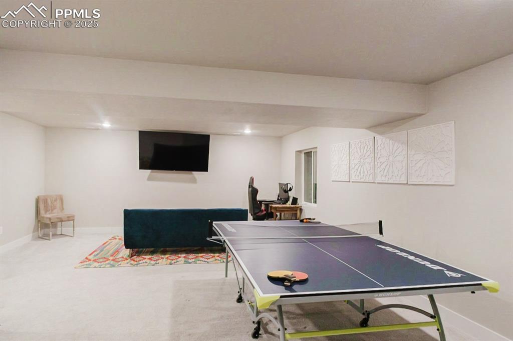 Image 32 of 37: The basement family room is spacious and bright.