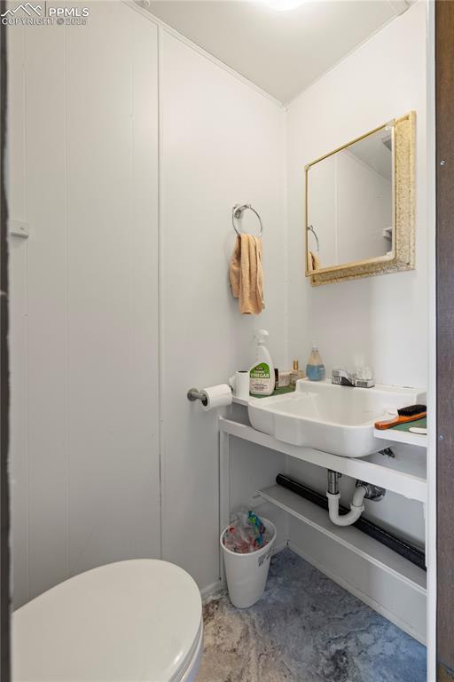 Image 24 of 31: Bathroom with toilet and a sink