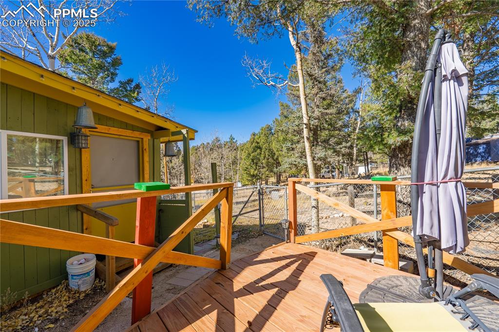 Image 3 of 31: Wooden terrace featuring a gate