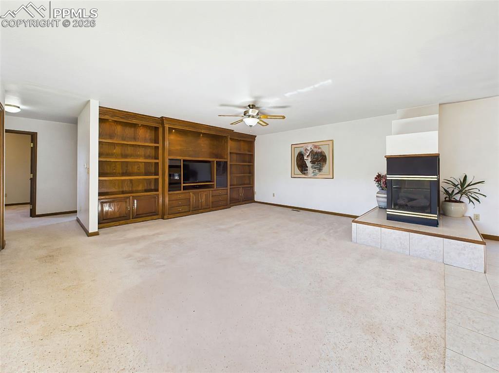 Image 13 of 50: Living Room (Unstaged) – Light-filled central living space with built-in st