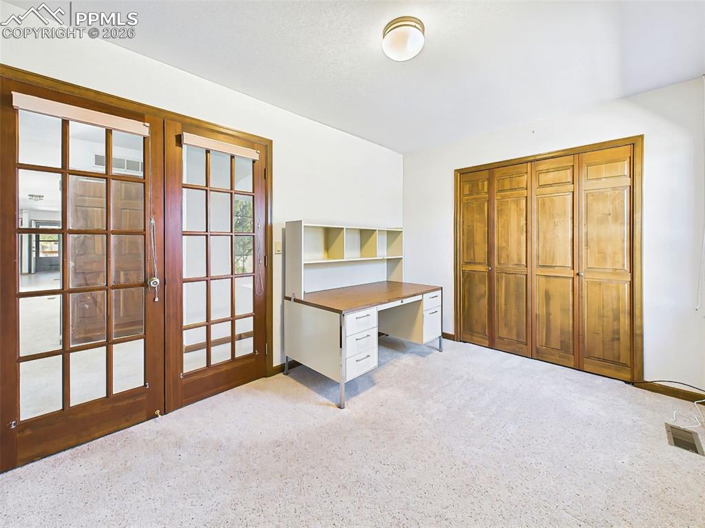 Image 26 of 50: Home Office or 3rd Bedroom – Flexible space featuring French doors and buil