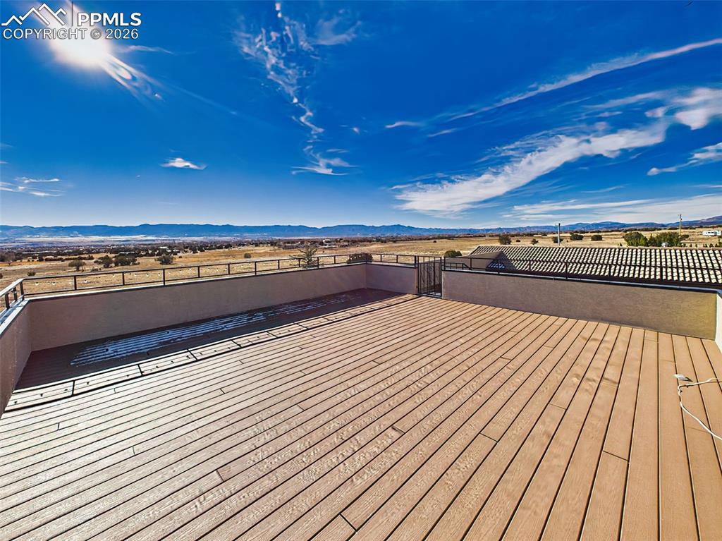 Image 37 of 50: Rooftop Deck (Unfurnished) – Spacious upper-level deck with safety railing