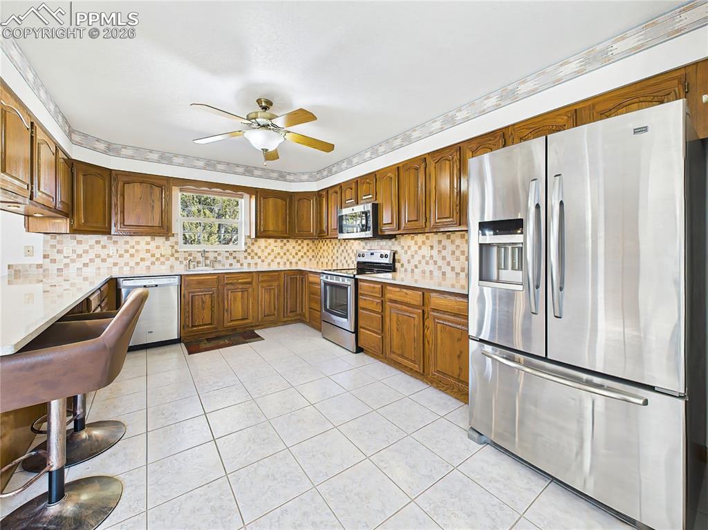 Image 4 of 50: Kitchen – Wide Angle – Expansive kitchen layout with ample prep space, mode