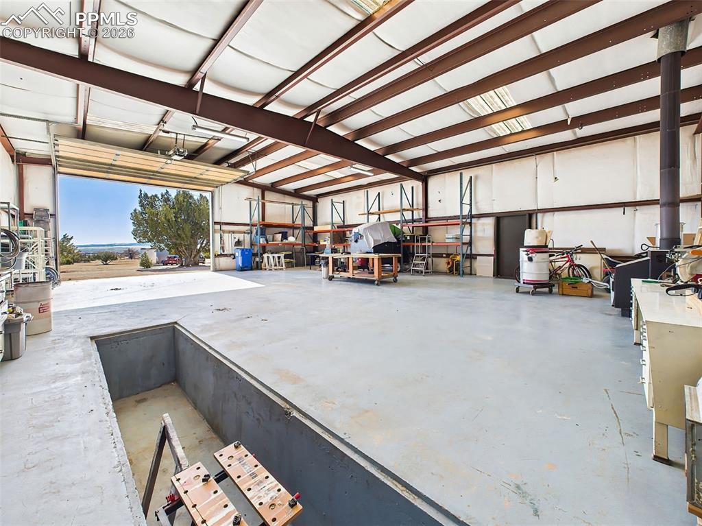 Image 42 of 50: Detached Shop Interior – Wide open shop space with tall ceilings, ample sto