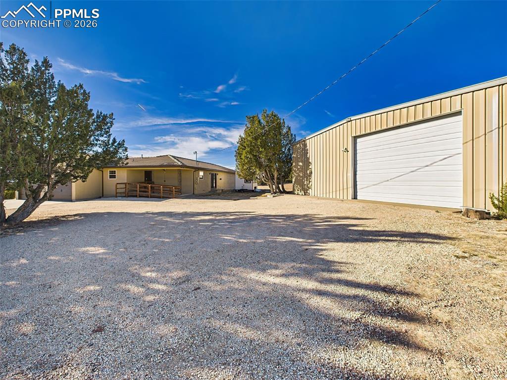 Image 45 of 50: Detached Shop Exterior – Large metal shop with wide access door, ample spac