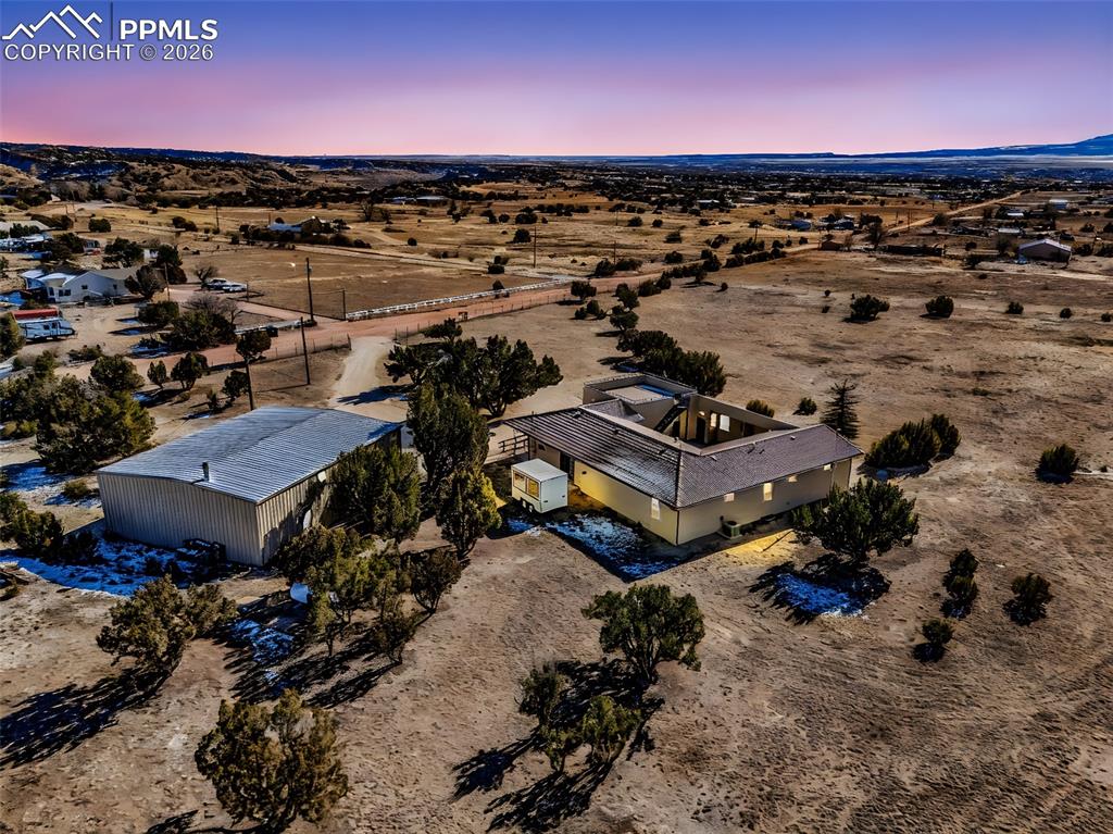Image 46 of 50: Backyard and Shop Overview – Wide-angle shot capturing the back of the home