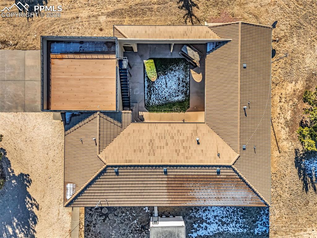 Image 47 of 50: Home Roof View with Courtyard – Overhead view highlights the unique courtya