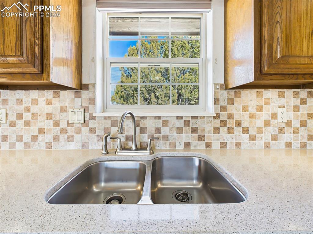 Image 6 of 50: Kitchen Sink Area – Dual stainless-steel sinks and updated fixtures sit bel