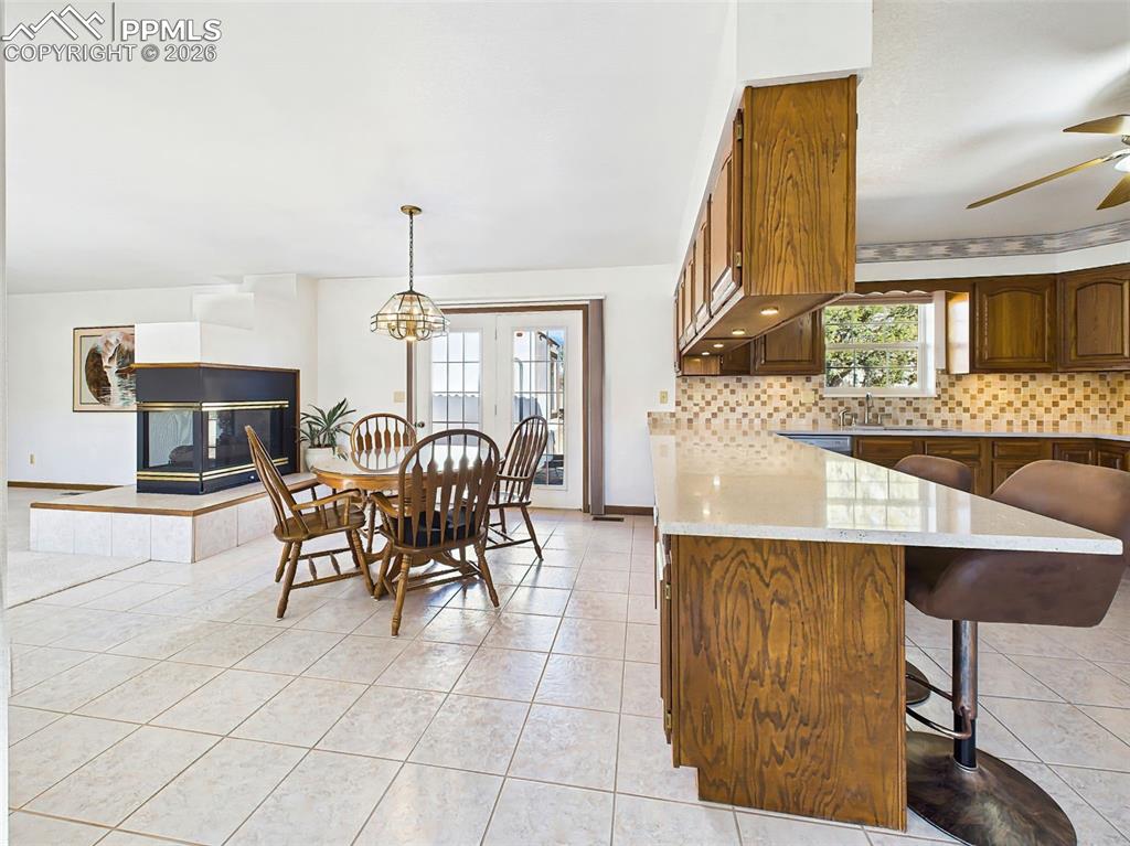 Image 9 of 50: Kitchen to Living View – This wide kitchen pass-through opens to the main l