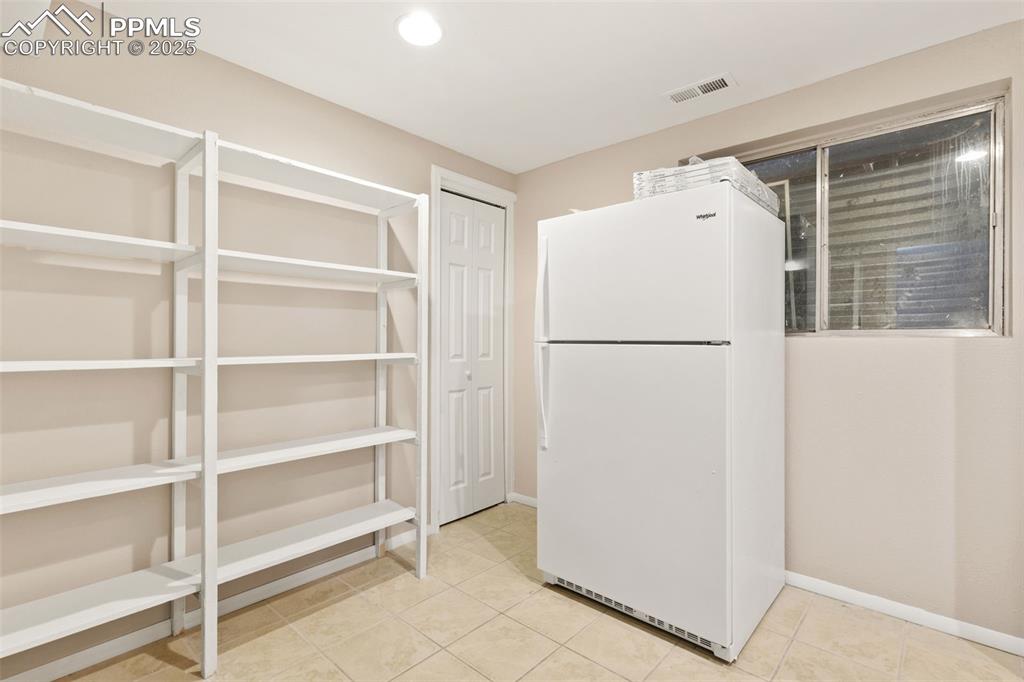 Image 25 of 27: laundry room with attached storage area