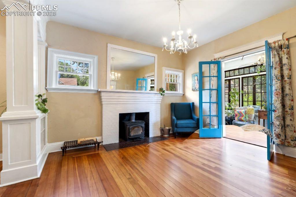 Image 2 of 49: Unfurnished room with hardwood / wood-style flooring, a chandelier, a wood 