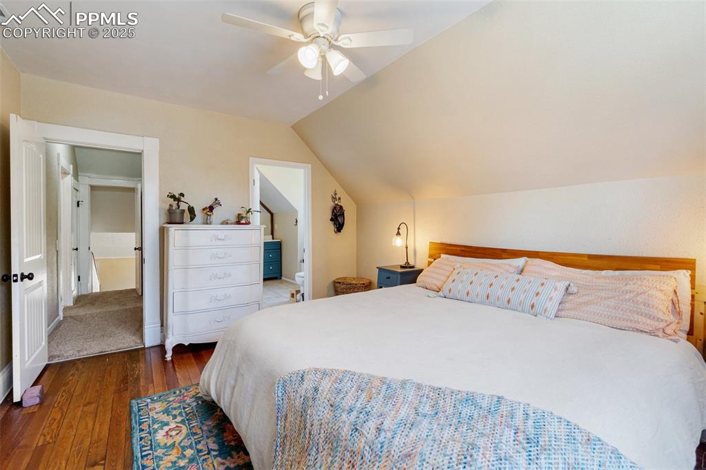 Image 21 of 49: Bedroom featuring dark wood finished floors, lofted ceiling, and a ceiling 