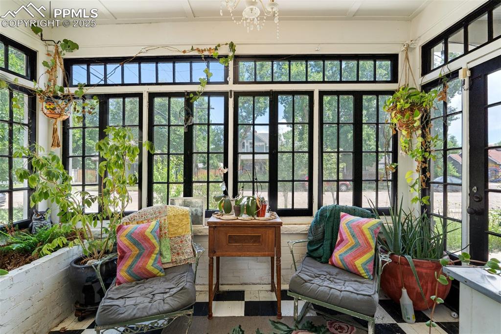 Image 4 of 49: Sunroom / solarium featuring plenty of natural light and a chandelier