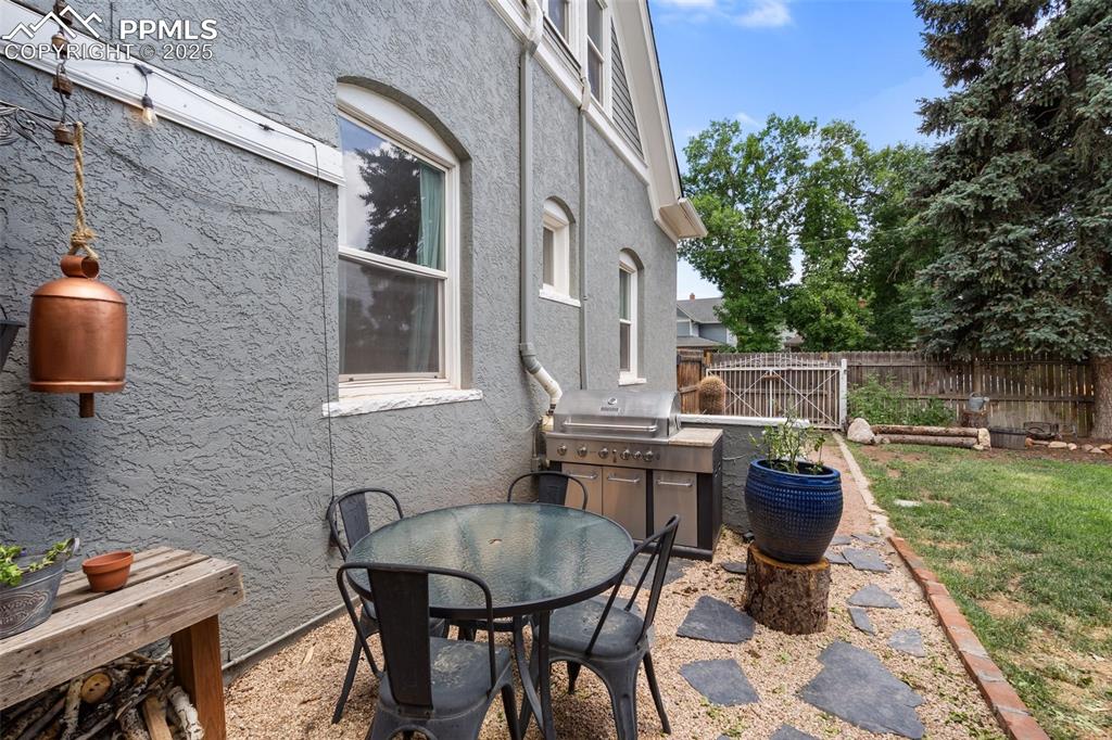 Image 44 of 49: View of patio featuring outdoor dining area and exterior kitchen