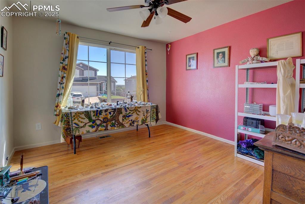 Image 21 of 44: Home office with ceiling fan and wood finished floors