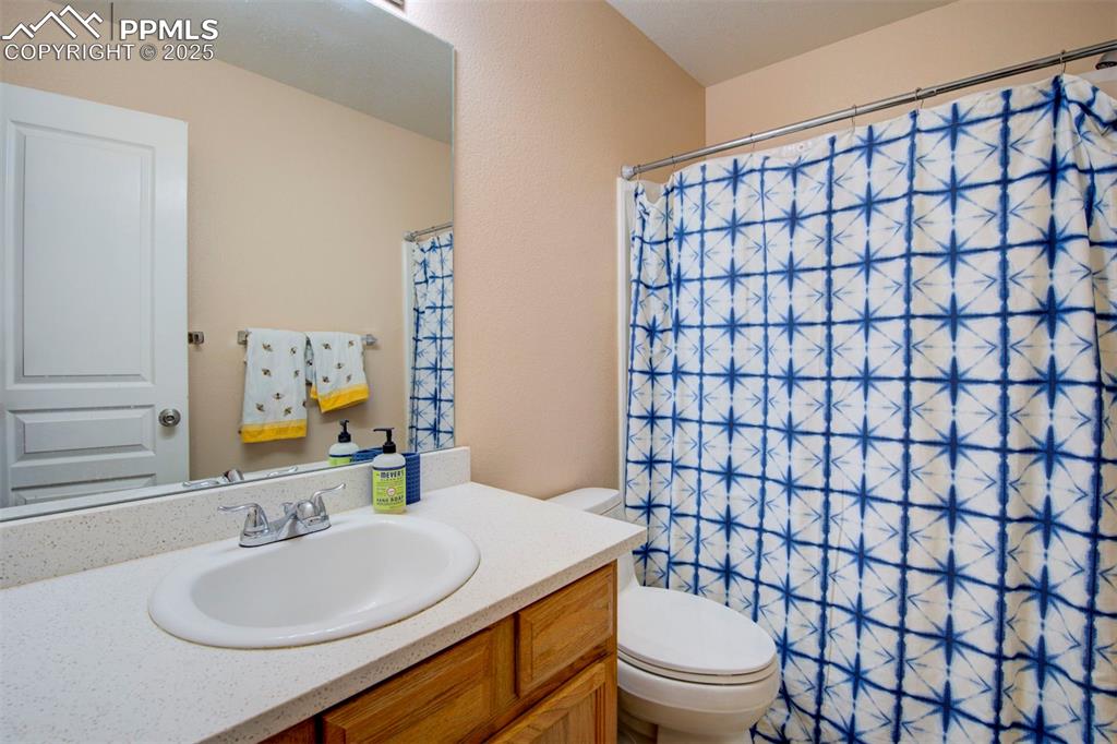 Image 25 of 44: Full bathroom with vanity and a shower with curtain