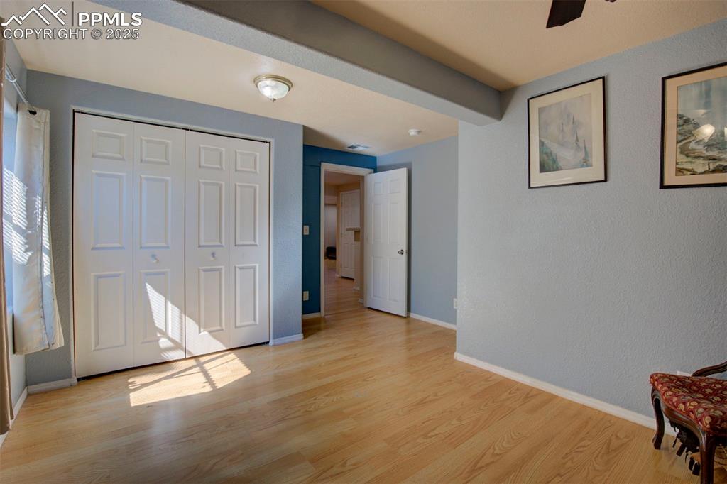 Image 26 of 44: Unfurnished bedroom with light wood finished floors, a closet, and a ceilin