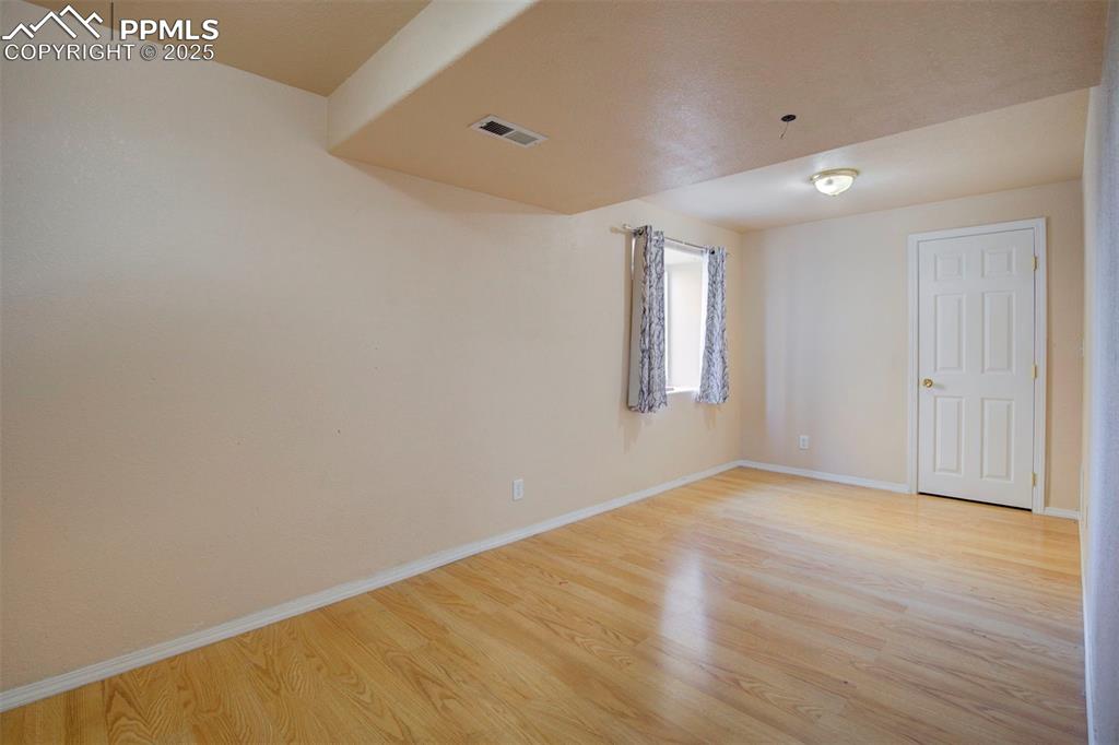 Image 33 of 44: Spare room with light wood-style flooring and baseboards