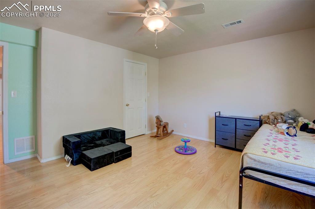 Image 34 of 44: Bedroom featuring light wood-style flooring and a ceiling fan